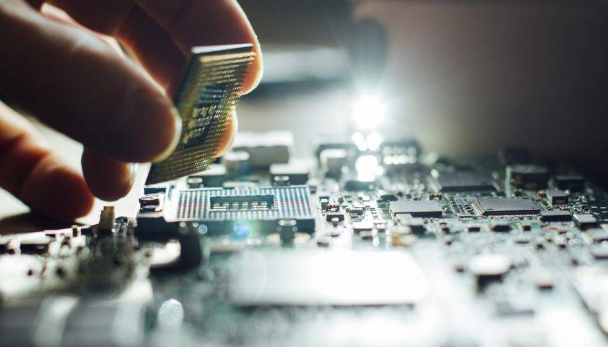 Connect Electronics computer chip and hand